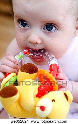 Picture - baby, bite, biting, blue eyes, child. Fotosearch