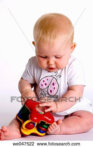 Baby playing with a toy View Large Photo Image Stock Image - Baby playing with a toy. Fotosearch