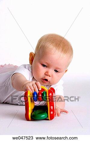 Baby playing with a toy View Large Photo Image Stock Image - Baby playing with a toy. Fotosearch
