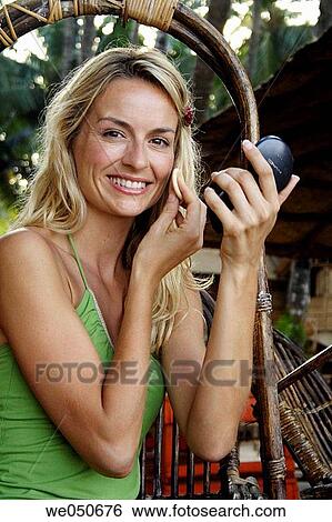 Beautiful blonde woman sat outside in the morning doing her make-up, shot in India. View Large Photo Image Stock Photograph - Beautiful blonde woman sat outside in the morning doing her make-up, shot in India.. Fotosearch