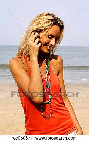 Beautiful blonde woman talking on the phone on an beach in India. View Large Photo Image Stock Image - Beautiful blonde woman talking on the phone on an beach in India.. Fotosearch