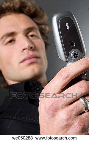 Stock Photo - calling, Close-up, cell phone, 20's. Fotosearch