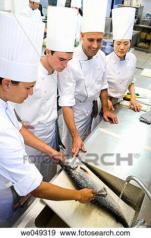 Stock Photo - Chefs boning salmon. Luis Irizar cooking school. Donostia, Gipuzkoa, Basque Country, Spain. Fotosearch
