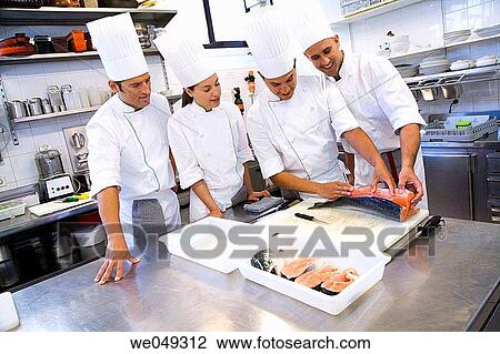Stock Image - Chefs cutting salmon. Luis Irizar cooking school. Donostia, Gipuzkoa, Basque Country, Spain. Fotosearch