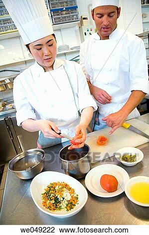 Stock Image - Chopping tomatoes and vegetables. Luis Irizar cooking school. Donostia, Gipuzkoa, Basque Country, Spain. Fotosearch