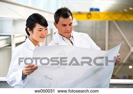 Fatronik Research Centre, San Sebastian Technological Park, Donostia, Gipuzkoa, Basque Country. Technicians looking at blueprints View Large Photo Image Stock Image - Fatronik Research Centre, San Sebastian Technological Park, Donostia, Gipuzkoa, Basque Country. Technicians looking at blueprints. Fotosearch