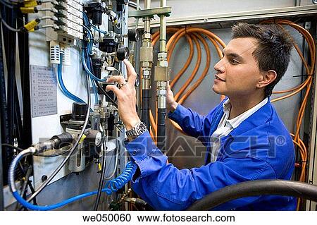 Fatronik Research Centre, San Sebastian Technological Park, Donostia, Gipuzkoa, Basque Country. Technician checking the electric and hydraulic systems of a tool-machine. View Large Photo Image Stock Image - Fatronik Research Centre, San Sebastian Technological Park, Donostia, Gipuzkoa, Basque Country. Technician checking the electric and hydraulic systems of a tool-machine.. Fotosearch