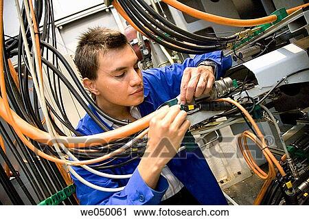 Fatronik Research Centre, San Sebastian Technological Park, Donostia, Gipuzkoa, Basque Country. Technician checking the electric and hydraulic systems of a tool-machine. View Large Photo Image Stock Image - Fatronik Research Centre, San Sebastian Technological Park, Donostia, Gipuzkoa, Basque Country. Technician checking the electric and hydraulic systems of a tool-machine.. Fotosearch