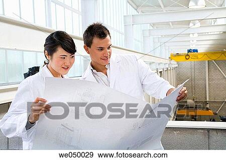 Fatronik Research Centre, San Sebastian Technological Park, Donostia, Gipuzkoa, Basque Country. Technicians looking at blueprints View Large Photo Image Stock Photo - Fatronik Research Centre, San Sebastian Technological Park, Donostia, Gipuzkoa, Basque Country. Technicians looking at blueprints. Fotosearch