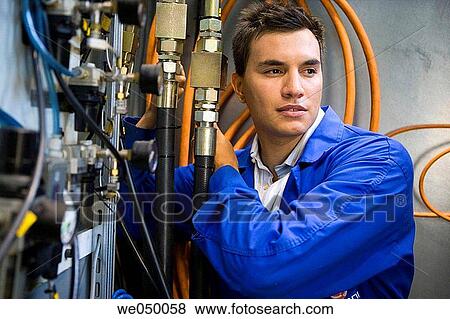 Fatronik Research Centre, San Sebastian Technological Park, Donostia, Gipuzkoa, Basque Country. Technician checking the electric and hydraulic systems of a tool-machine. View Large Photo Image Stock Photo - Fatronik Research Centre, San Sebastian Technological Park, Donostia, Gipuzkoa, Basque Country. Technician checking the electric and hydraulic systems of a tool-machine.. Fotosearch