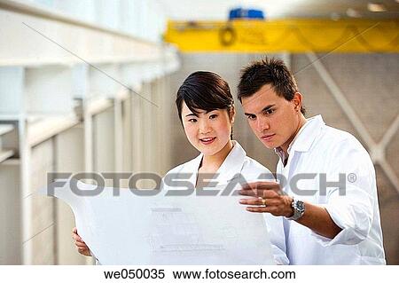 Fatronik Research Centre, San Sebastian Technological Park, Donostia, Gipuzkoa, Basque Country. Technicians looking at blueprints View Large Photo Image Stock Photography - Fatronik Research Centre, San Sebastian Technological Park, Donostia, Gipuzkoa, Basque Country. Technicians looking at blueprints. Fotosearch