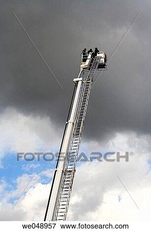 Firemen on the ladder in training. View Large Photo Image Stock Photo - Firemen on the ladder in training.. Fotosearch