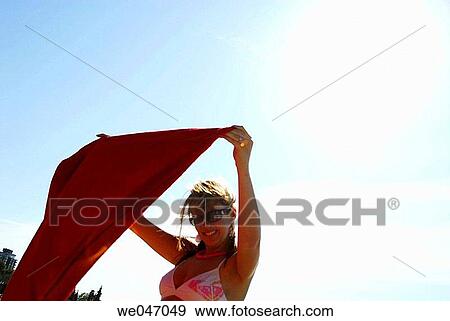 girl/woman 20 yrs old holding up towel at beach View Large Photo Image Stock Photo - girl/woman 20 yrs old holding up towel at beach. Fotosearch
