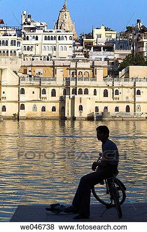 Indian man and bicycle admiring the view of the city and Lake Pichola. Udaipur. Rajasthan. India View Large Photo Image Stock Photo - Indian man and bicycle admiring the view of the city and Lake Pichola. Udaipur. Rajasthan. India. Fotosearch