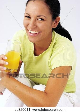 Latin woman drinking orange juice View Large Photo Image Stock Image - Latin woman drinking orange juice. Fotosearch