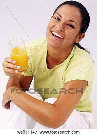 Latin woman drinking orange juice View Large Photo Image Stock Photo - Latin woman drinking orange juice. Fotosearch