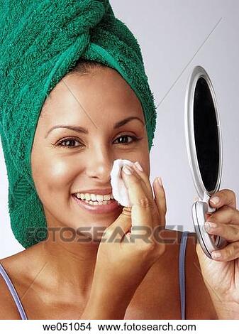 Lating woman cleaning her face View Large Photo Image Picture - Lating woman cleaning her face. Fotosearch