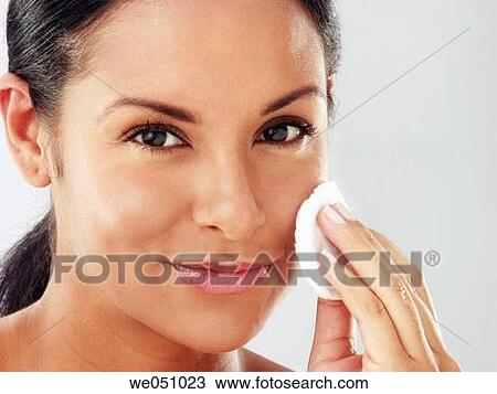 Lating woman cleaning her face View Large Photo Image Stock Image - Lating woman cleaning her face. Fotosearch