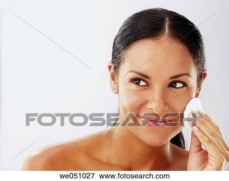 Stock Photo - Lating woman cleaning her face. Fotosearch