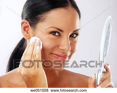 Lating woman cleaning her face View Large Photo Image Stock Photo - Lating woman cleaning her face. Fotosearch