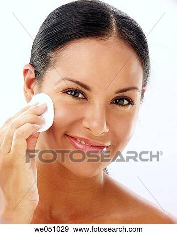 Stock Photo - Lating woman cleaning her face. Fotosearch