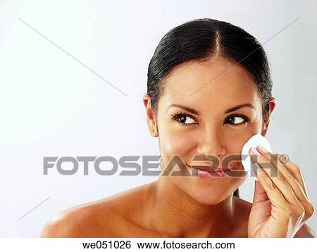 Lating woman cleaning her face View Large Photo Image Stock Photograph - Lating woman cleaning her face. Fotosearch