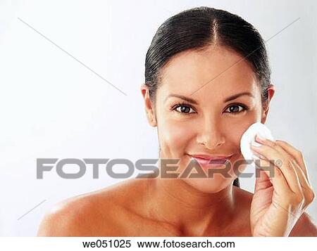 Lating woman cleaning her face View Large Photo Image Stock Photography - Lating woman cleaning her face. Fotosearch