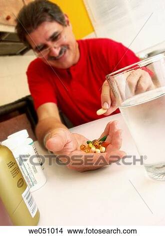 Man taking pills. View Large Photo Image Picture - Man taking pills.. Fotosearch