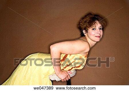 Middle-age woman leaning on a stool View Large Photo Image Stock Photo - Middle-age woman leaning on a stool. Fotosearch