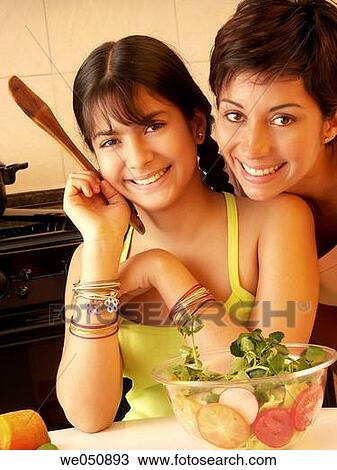 Stock Image - MOTHER AND SON IN KITCHEN. MOTHER IN KITCHEN. MOTHER AND SON COOKING. MOTHER COOKING.. Fotosearch