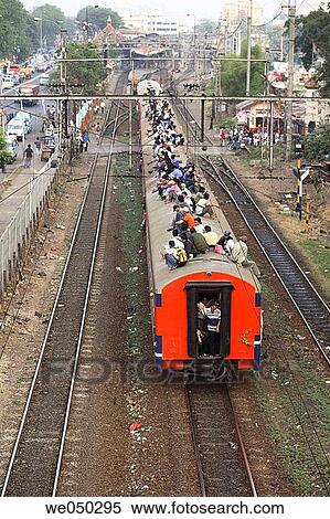 Passangers sit on roof of a packed train, Jakarta, Indonesia, South East Asia View Large Photo Image Stock Photography - Passangers sit on roof of a packed train, Jakarta, Indonesia, South East Asia. Fotosearch