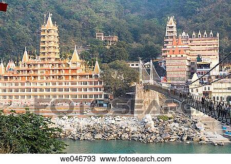 Pedestrian bridge over the Ganges River in the yoga capital of the world. Rishikesh. Uttaranchal. India. View Large Photo Image Stock Image - Pedestrian bridge over the Ganges River in the yoga capital of the world. Rishikesh. Uttaranchal. India.. Fotosearch