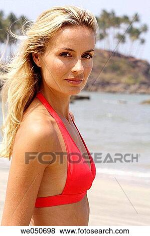 Portrait of beautiful blonde woman in red bikini top on a beach in India. View Large Photo Image Stock Photo - Portrait of beautiful blonde woman in red bikini top on a beach in India.. Fotosearch