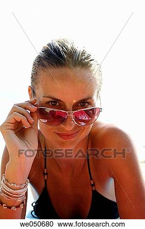 Portrait of blonde woman in sunglasses looking at camera, shot on a beach in India. View Large Photo Image Stock Image - Portrait of blonde woman in sunglasses looking at camera, shot on a beach in India.. Fotosearch