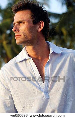 Profile shot of good-looking man with palm trees in background. View Large Photo Image Stock Photograph - Profile shot of good-looking man with palm trees in background.. Fotosearch