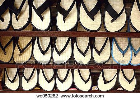 Stock Image - Sandals on display rack, Hoi An, Vietnam, South East Asia. Fotosearch
