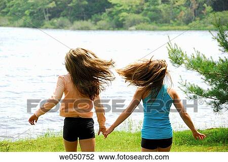sisters 13 and 18 yrs running together toward lake View Large Photo Image Stock Image - sisters 13 and 18 yrs running together toward lake. Fotosearch
