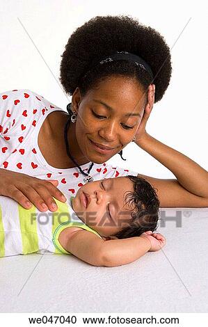 Teenage mother and sleeping baby View Large Photo Image Stock Image - Teenage mother and sleeping baby. Fotosearch