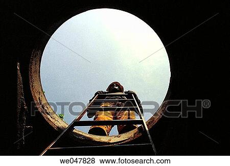 Stock Photo - Telephone Company employee. Underground work.. Fotosearch