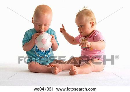 Two toddlers playing with a ball View Large Photo Image Stock Image - Two toddlers playing with a ball. Fotosearch