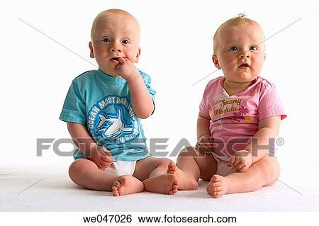 Two toddlers sitting besides each other View Large Photo Image Stock Photograph - Two toddlers sitting besides each other. Fotosearch