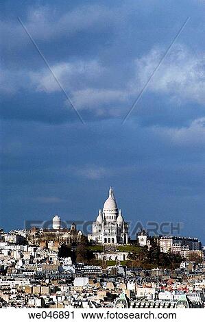 Stock Image - View of Paris rooftops with Sacr? Coeur Church in the background. Paris. France. Fotosearch