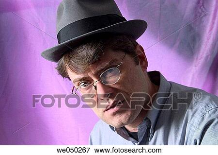 Young man, wearing glasses and a hat, posing View Large Photo Image Stock Photo - Young man, wearing glasses and a hat, posing. Fotosearch