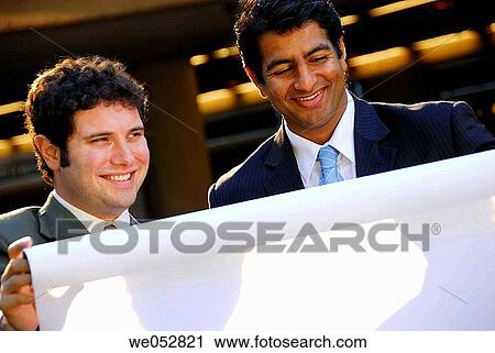 2 young male business men holding architect plans View Large Photo Image Stock Image - 2 young male business men holding architect plans. Fotosearch