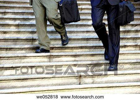 2 young male business men running down stairs View Large Photo Image Stock Photo - 2 young male business men running down stairs. Fotosearch