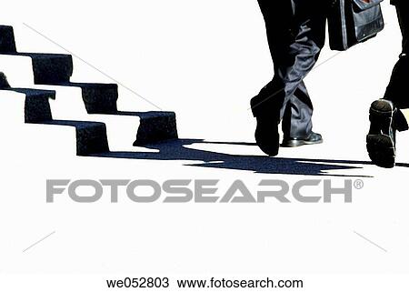 2 young male business men walking together beside stairway View Large Photo Image Stock Image - 2 young male business men walking together beside stairway. Fotosearch
