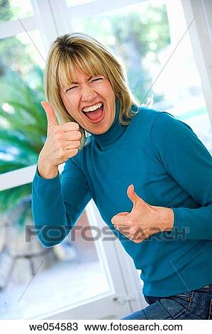 Stock Image - achievement, blond, at-home, approval, 30's. Fotosearch