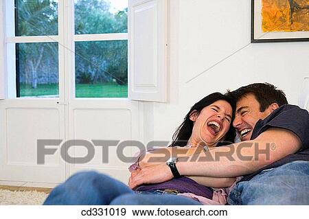 Stock Photo - affection, black hair, at-home, amusement, 30's. Fotosearch