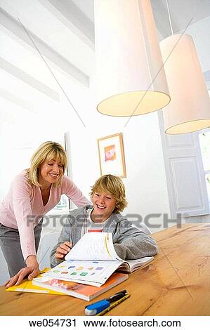 Stock Image - affection, book, at-home, aid, 30's. Fotosearch