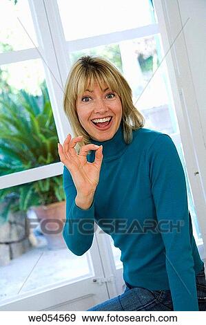 Stock Photo - approval, blond, at-home, 30's. Fotosearch